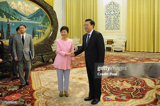 South Korean President Park Geun-Hye shakes hands with Chinese Chairman of the National People's Congress Zhang Dejiang at the Great Hall of the...