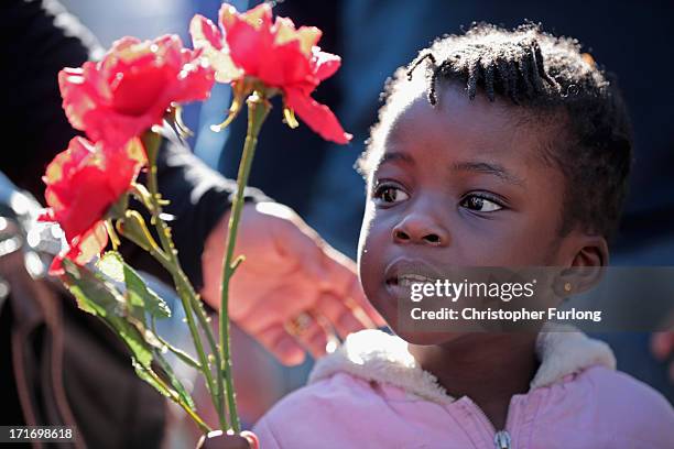 Young children sing and bring flowers in honour of Nelson Mandela outside the Mediclinic Heart Hospital where he is being treated on June 28, 2013 in...