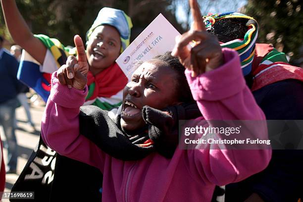 People sing in honour of Nelson Mandela outside the Mediclinic Heart Hospital where he is being treated on June 28, 2013 in Pretoria, South Africa....