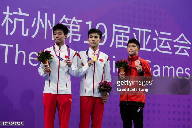 Yang Hao , Bai Yuming of China, Tamai Rikuto of Japan pose with their medals on the medal ceremony after the Diving Men's 10m Platform Final Final...