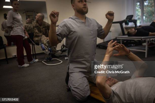Soldiers do physical therapy at a rehabilitation center for soldiers suffering from injuries and psychological trauma on October 04, 2023 in Kyiv,...