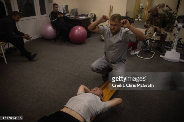 Soldiers do physical therapy at a rehabilitation center for soldiers suffering from injuries and psychological trauma on October 04, 2023 in Kyiv,...