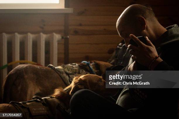 Soldier pats a therapy dog during a dog therapy session at a rehabilitation center for soldiers suffering from injuries and psychological trauma on...