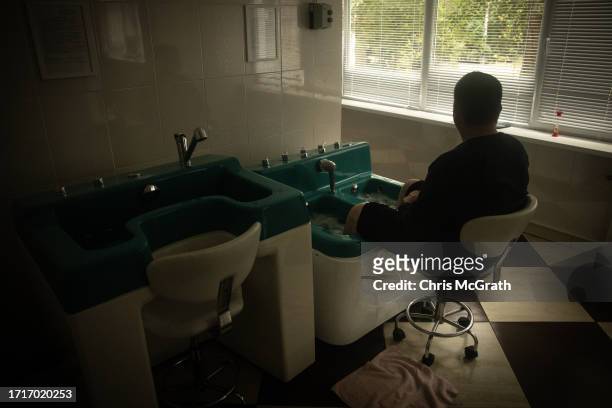 Soldier relaxes while using a water therapy machine at a rehabilitation center for soldiers suffering from injuries and psychological trauma on...