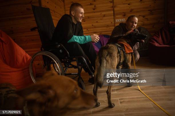 Year old Oleksandr, suffering from phosphorus burns and shrapnel wounds to his footsustained during fighting in Zaporizhzhia takes part in a dog...