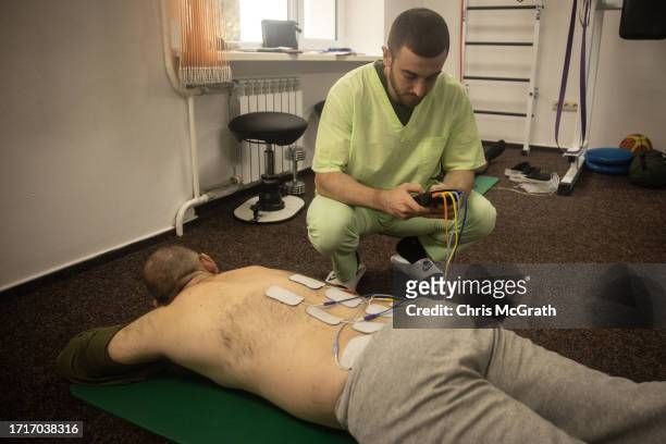 Physical therapist administers electrotherapy to a soldier at a rehabilitation center for soldiers suffering from injuries and psychological trauma...
