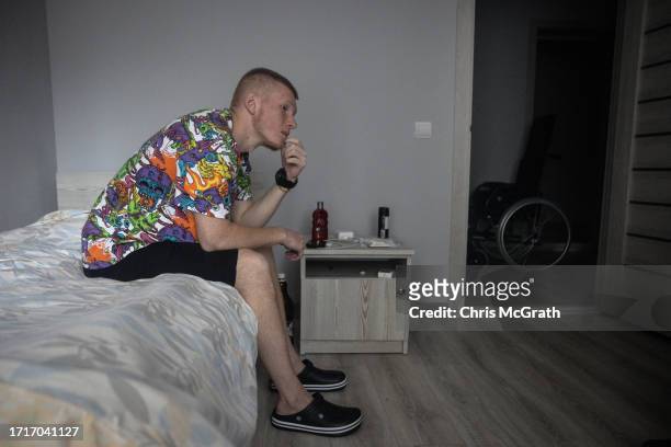 Year old Oleksandr, suffering from phosphorus burns and shrapnel wounds to his foot sustained during fighting in Zaporizhzhia rests on his bed as his...
