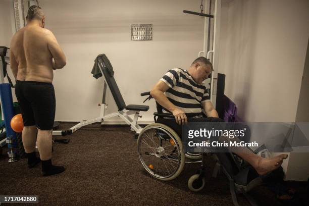 Year-old amputee soldier Valeriy prepares for a physical therapy session at a rehabilitation center for soldiers suffering from injuries and...