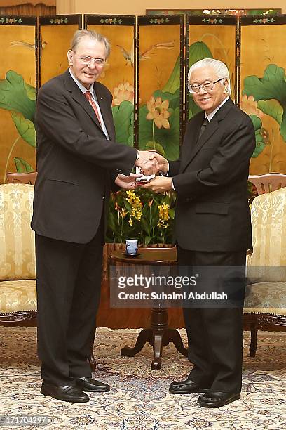 Singapore President, Tony Tan Keng Yam confers the Public Service Star on President of the International Olympic Committee , Dr Jacques Rogge , to...