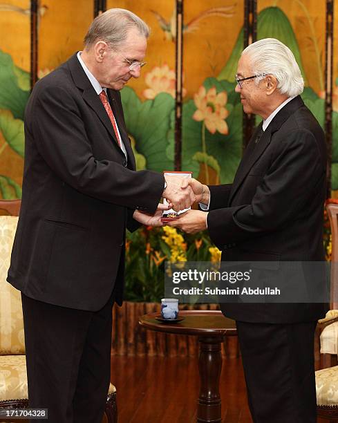 Singapore President, Tony Tan Keng Yam confers the Public Service Star on President of the International Olympic Committee , Dr Jacques Rogge , to...