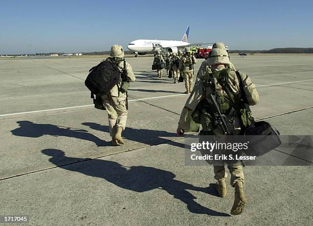 Soldiers from the Third Infantry, based at Fort Benning, board a charter plane to Kuwait January 9, 2003 at Robins Air Force Base, Georgia. The Third...