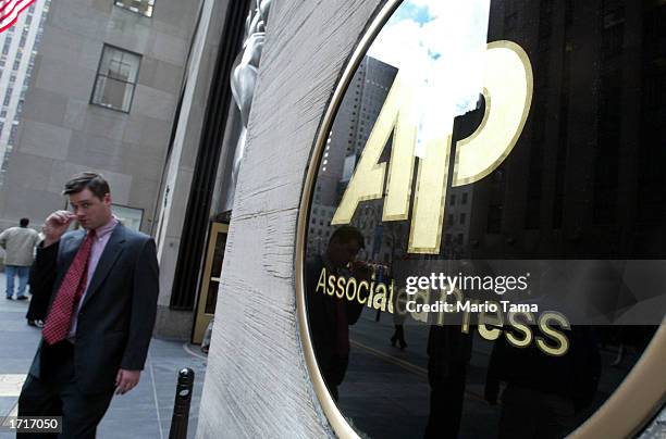 Man walks out of Associated Press headquarters January 9, 2003 in New York City. Because of a contract dispute about 1,700 reporters, photographers...