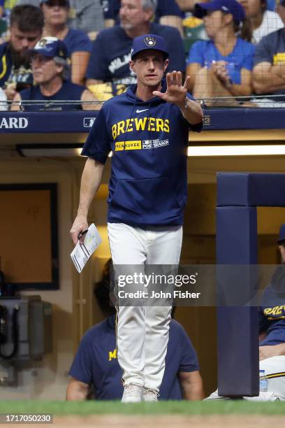 Craig Counsell of the Milwaukee Brewers ask for time against the Arizona Diamondbacks during Game One of the Wild Card Series at American Family...