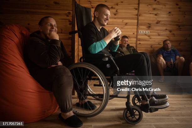 Year old Oleksandr, suffering from phosphorus burns and shrapnel wounds to his foot sustained during fighting in Zaporizhzhia takes part in a dog...