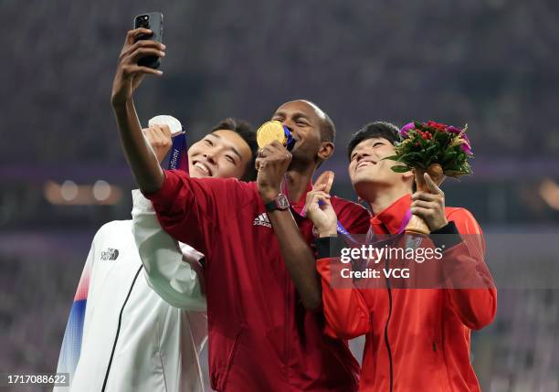 Silver medalist Woo Sang-hyeok of Team South Korea, gold medalist Mutaz Barshim of Team Qatar and bronze medalist Tomohiro Shinno of Team Japan pose...