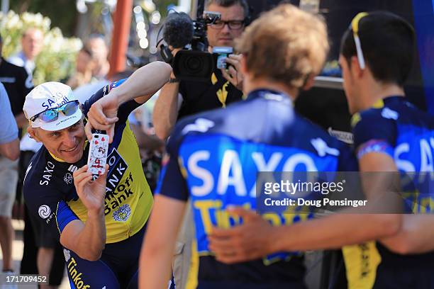 Oleg Tinkoff , co-sponsor of Team Saxo-Tinkoff, takes a photo of Alberto Contador of Spain riding for Team Saxo-Tinkoff prior to a training ride on...