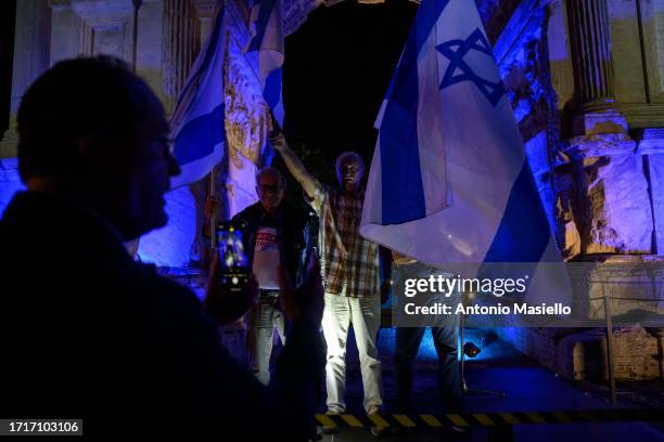 People wave Israeli flag during a Pro-Israel demonstration next to the Arco di Tito, on October 9, 2023 in Rome, Italy. On October 7, the Palestinian...