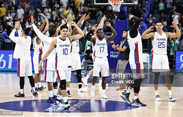 Players of Team Philippines celebrate victory after the Basketball - Men's Semi-final match between Philippines and China on day 11 of the 19th Asian...