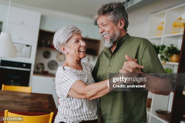 portrait of a senior couple having fun - couple dancing stock pictures, royalty-free photos & images