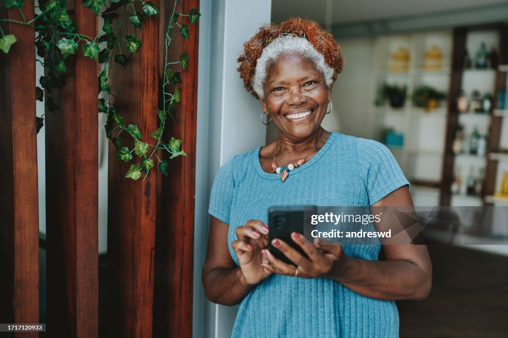 Portrait senior woman using smartphone smiling