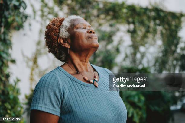 porträt seniorin atmet - deep breathing stock-fotos und bilder