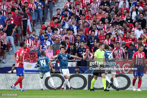 Ayase Ueda of Feyenoord celebrates with Igor Paixao and Mats Wieffer of Feyenoord as Mario Hermoso of Atletico Madrid scores an own-goal during the...