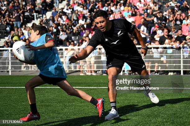 Anton Lienert-Brown of the All Blacks runs through drills with school children at Matmut Stadium ahead of their Rugby World Cup France 2023 match...