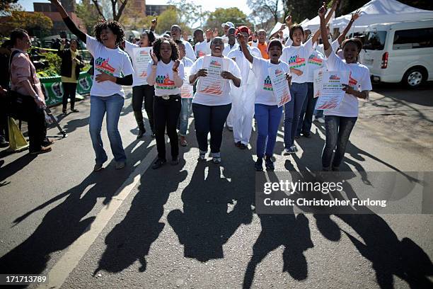 Gospel choir sing and dance in honour of Nelson Mandela outside the Mediclinic Heart Hospital where he is being treated on June 28, 2013 in Pretoria,...