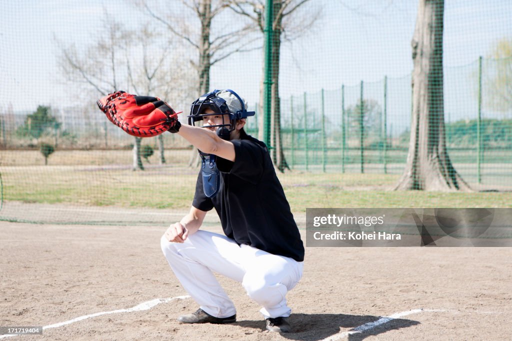 Asian man playing baseball