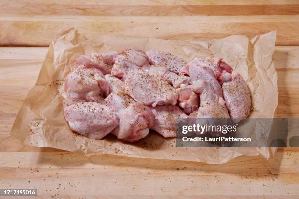 seasoning raw split chicken wings - marinated stock pictures, royalty-free photos & images