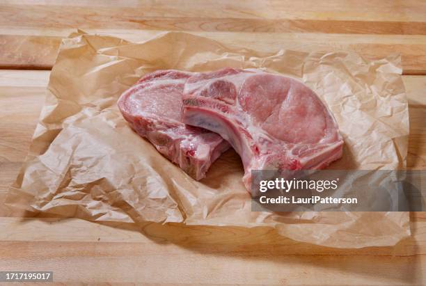 raw pork loin bone in rib end chop - butcher paper stock pictures, royalty-free photos & images