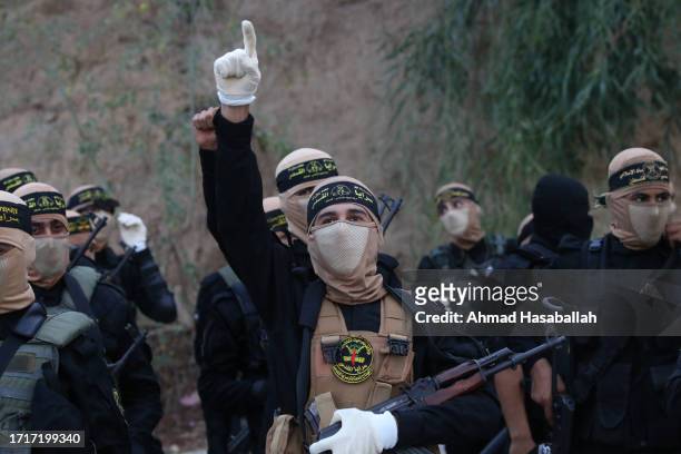 Members of the Al-Quds Brigades, the military wing of the Islamic Jihad movement, march during a military parade marking the 36th anniversary of its...