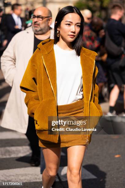Yoyo Cao wears a white t-shirt, mustard yellow Miu Miu jacket with matching mini skirt, outside Miu Miu, during the Womenswear Spring/Summer 2024 as...
