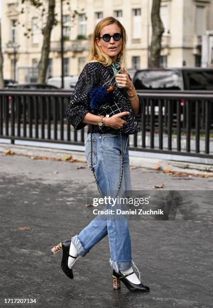 Blanca Miro Scrimieri is seen wearing a Chanel top, Chanel bag, blue jeans and black sunglasses outside the Chanel show during the Womenswear...