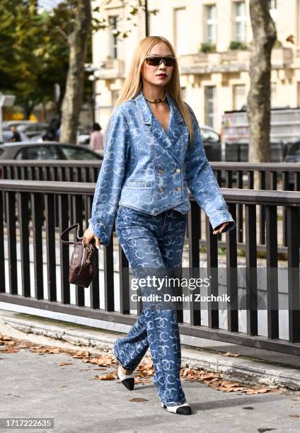 Niki Wu Jie is seen wearing a Chanel blue jacket and pants with a Chanel bag and umbrella outside the Chanel show during the Womenswear Spring/Summer...