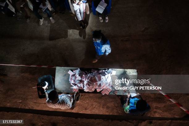 Election officials start counting the ballots of the general elections at a polling station in Monrovia on October 10, 2023. Liberians voted on...