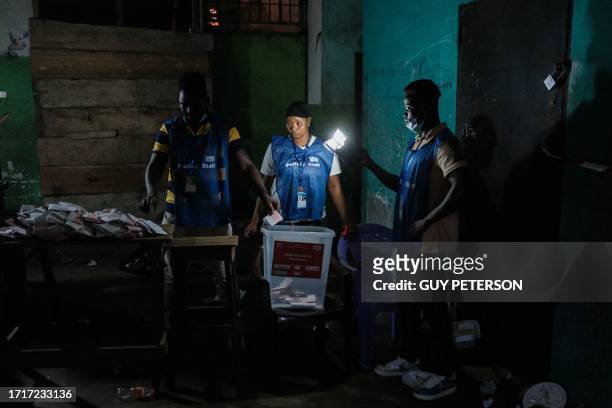 Election officials start counting the ballots of the general elections at a polling station in West Point in Monrovia, on October 10, 2023. Liberians...