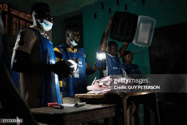 Election officials start counting the ballots of the general elections at a polling station in West Point in Monrovia, on October 10, 2023. Liberians...