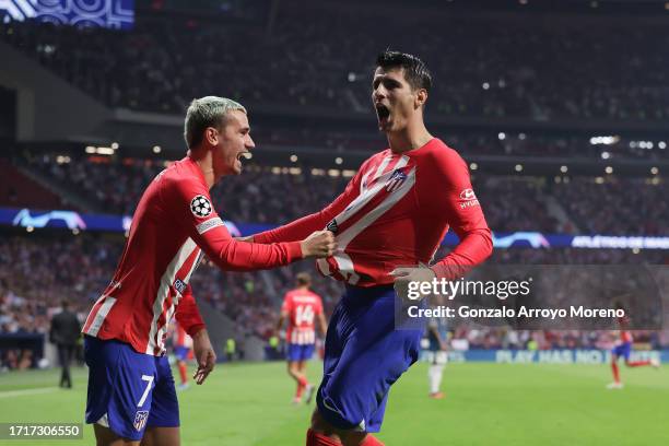 Alvaro Morata celebrates scoring their third goal during with teammate Antoine Griezmann the UEFA Champions League match between Atletico Madrid and...