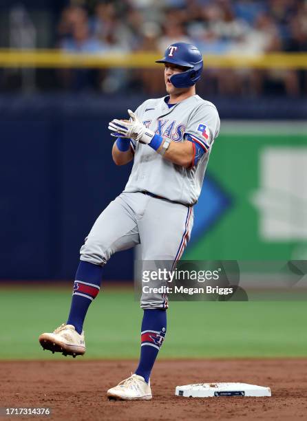 Josh Jung of the Texas Rangers reacts after hitting a double in the third inning against theTampa Bay Rays during Game Two of the Wild Card Series at...