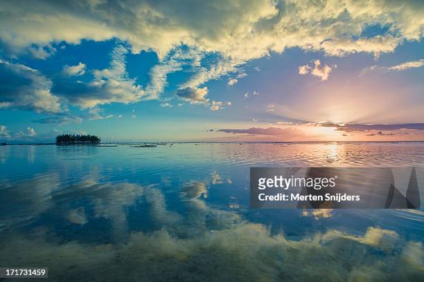 motu reflections on the lagoon at hauru point - moorea stock pictures, royalty-free photos & images