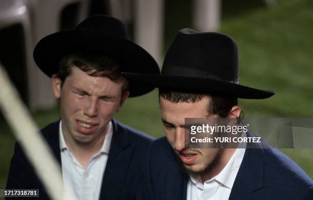 Israelis mourn as they attend the funeral of Israeli army soldier Noam Elimeleh Rothenberg at Mount Herzl Cemetery in Jerusalem on October 10, 2023....