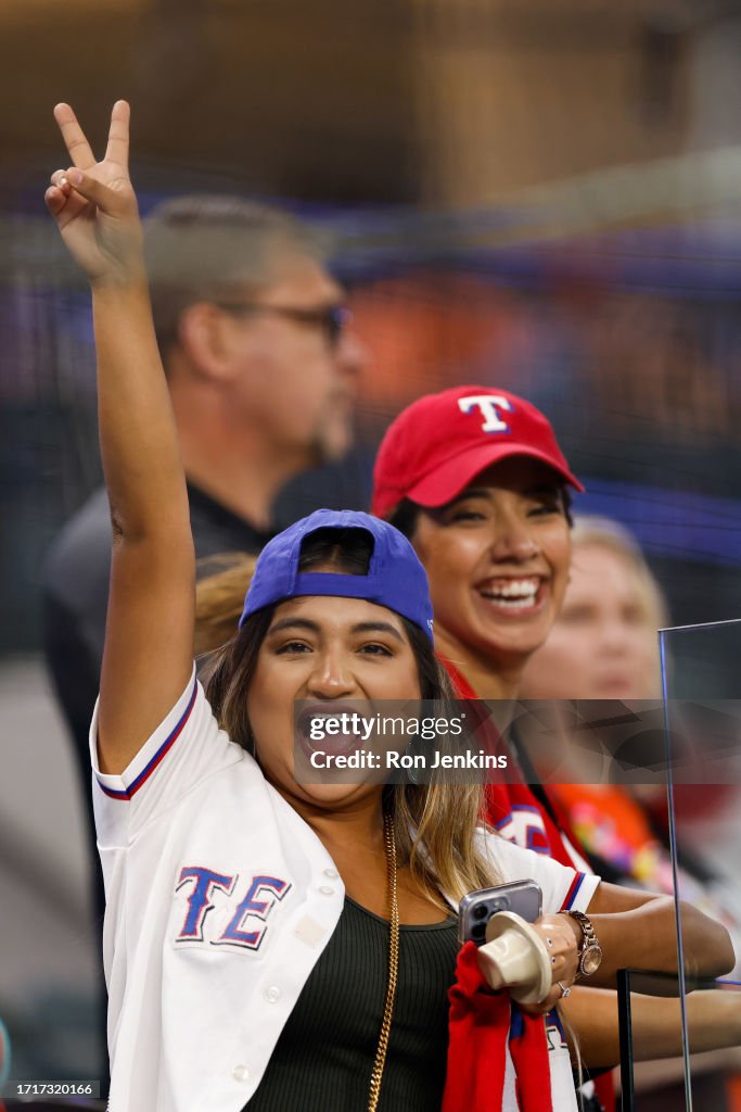 Texas Rangers Field Reporter A Texas Rangers fan poses for a photo during batting practice prior ...