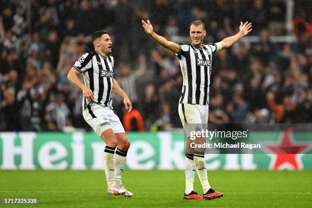 Dan Burn of Newcastle United celebrates with Fabian Schaer of Newcastle United after scoring the team's second goal during the UEFA Champions League...