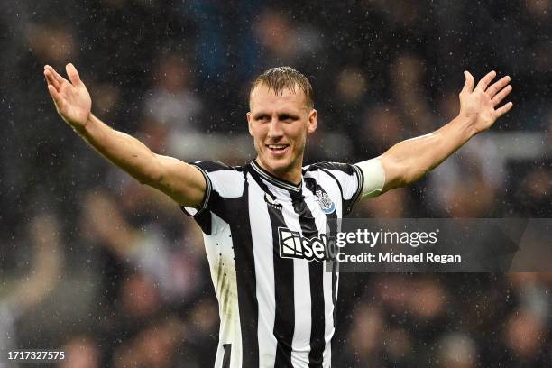 Dan Burn of Newcastle United celebrates after scoring the team's second goal during the UEFA Champions League match between Newcastle United FC and...