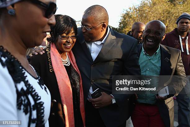 Former wife of Nelson Mandela Winnie Madikizela-Mandela leaves after speaking to the press outside Nelson Mandela House in Soweto on June 28, 2013 in...