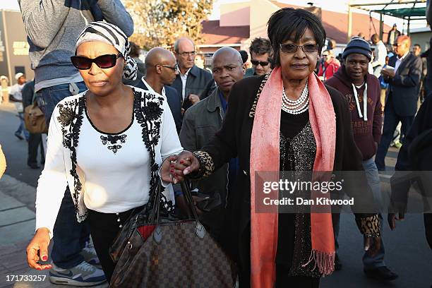 Former wife of Nelson Mandela Winnie Madikizela-Mandela leaves after speaking to the press outside Nelson Mandela House in Soweto on June 28, 2013 in...