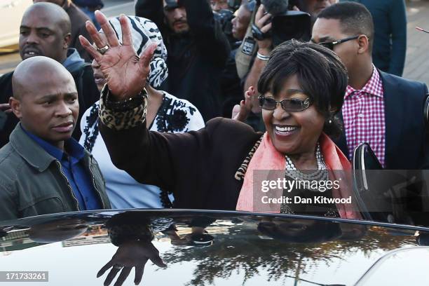 Former wife of Nelson Mandela Winnie Madikizela-Mandela waves after speaking to the press outside Nelson Mandela House in Soweto on June 28, 2013 in...