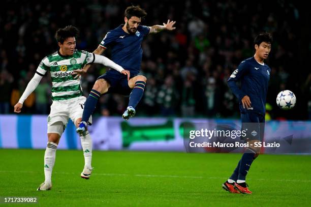 Luis Alberto of SS Lazio competes for the ball with Hyunjun Yang of Celtic FC during the UEFA Champions League match between Celtic FC and SS Lazio...