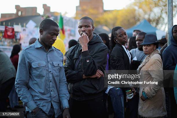 People wait for news outside the Mediclinic Heart Hospital where Nelson Mandela is being treated on June 28, 2013 in Pretoria, South Africa. People...